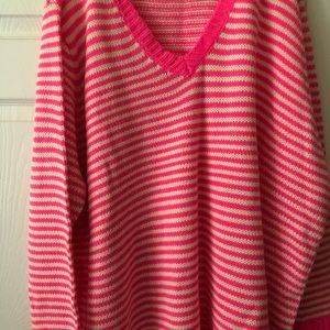 Pink and white sweater.                                    102